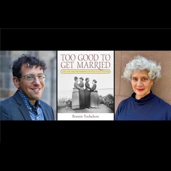 A man and woman smiling next to a book