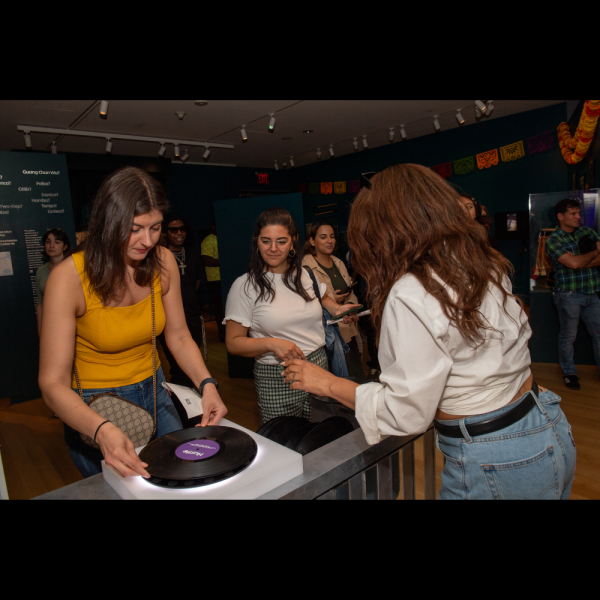 Women spinning a record at the Museum of the City of New York