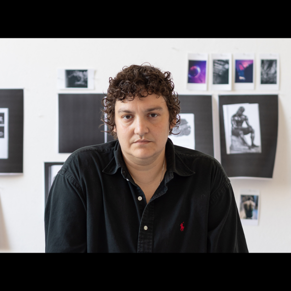 A woman in a black long sleeve shirt with short brown hair