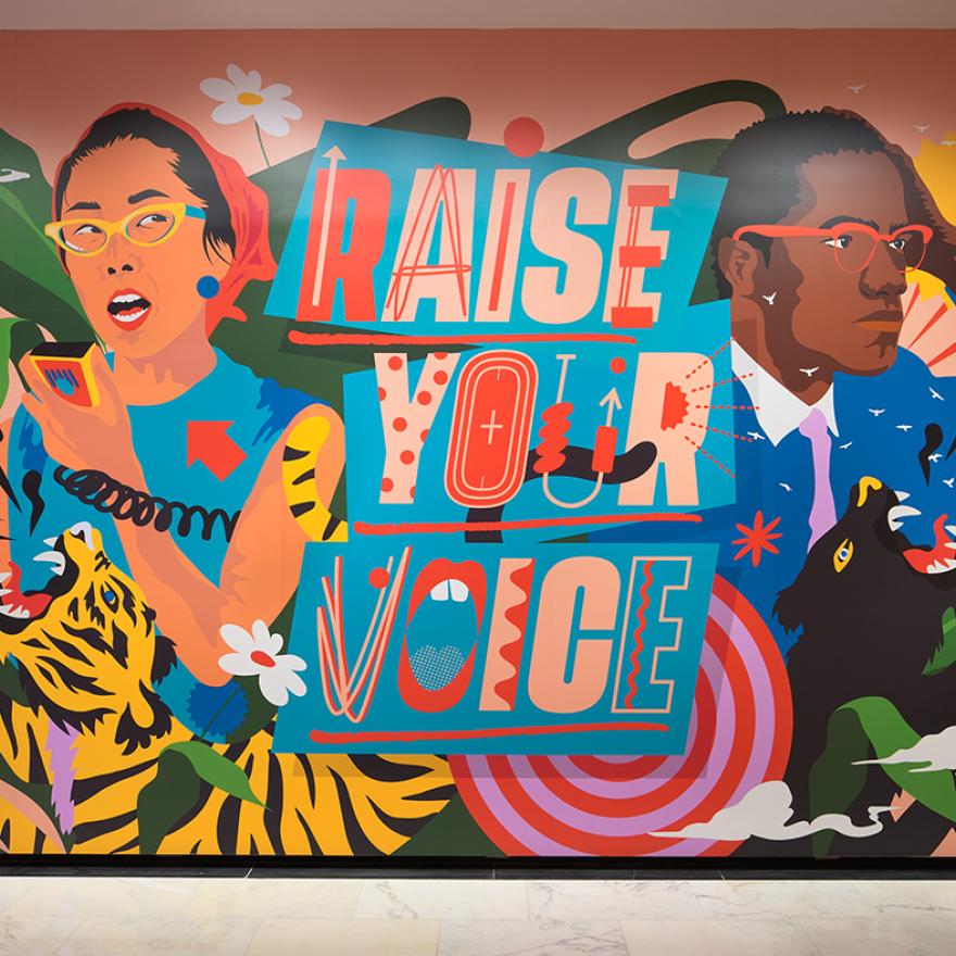 Photograph of the immersive installation "Raise Your Voice," original artwork of activists and allies Yuri Kochiyama and Malcolm X by artist Amanda Phingbodhipakkiya.