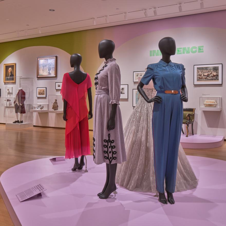Three mannequins are displayed in a gallery.