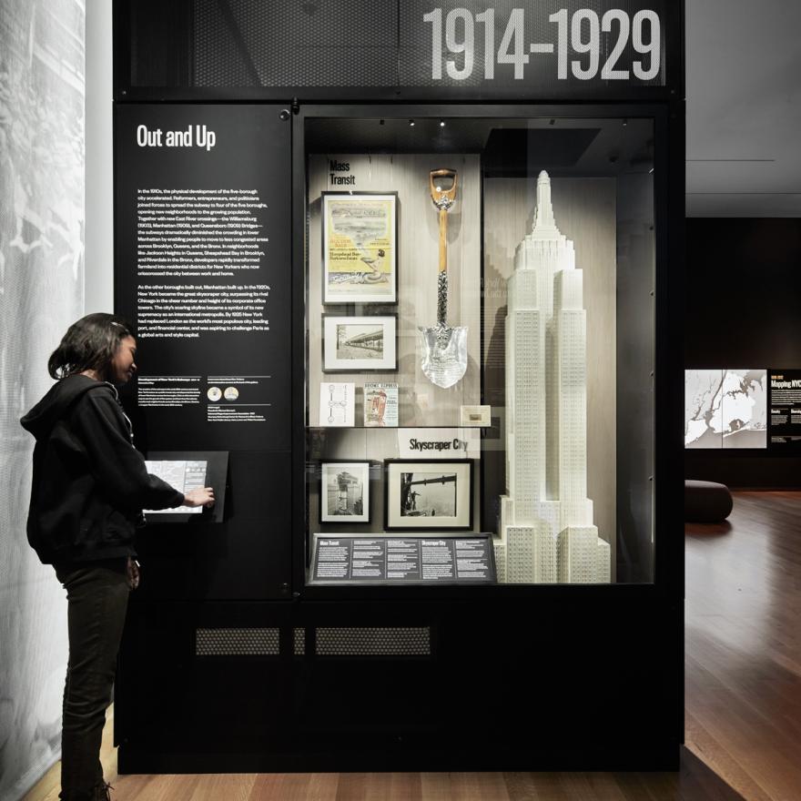 A visitor uses an interactive screen to learn more about the exhibition in front of her