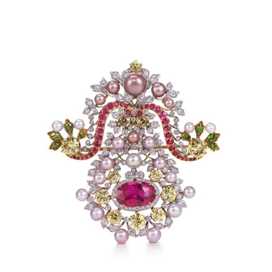 Brooch made of a metal backing with pink, yellow, and green diamonds, pink and white pearls, and silver leaves