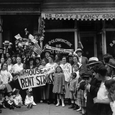 A group of men, women, and children during a rent strike in Harlem. 