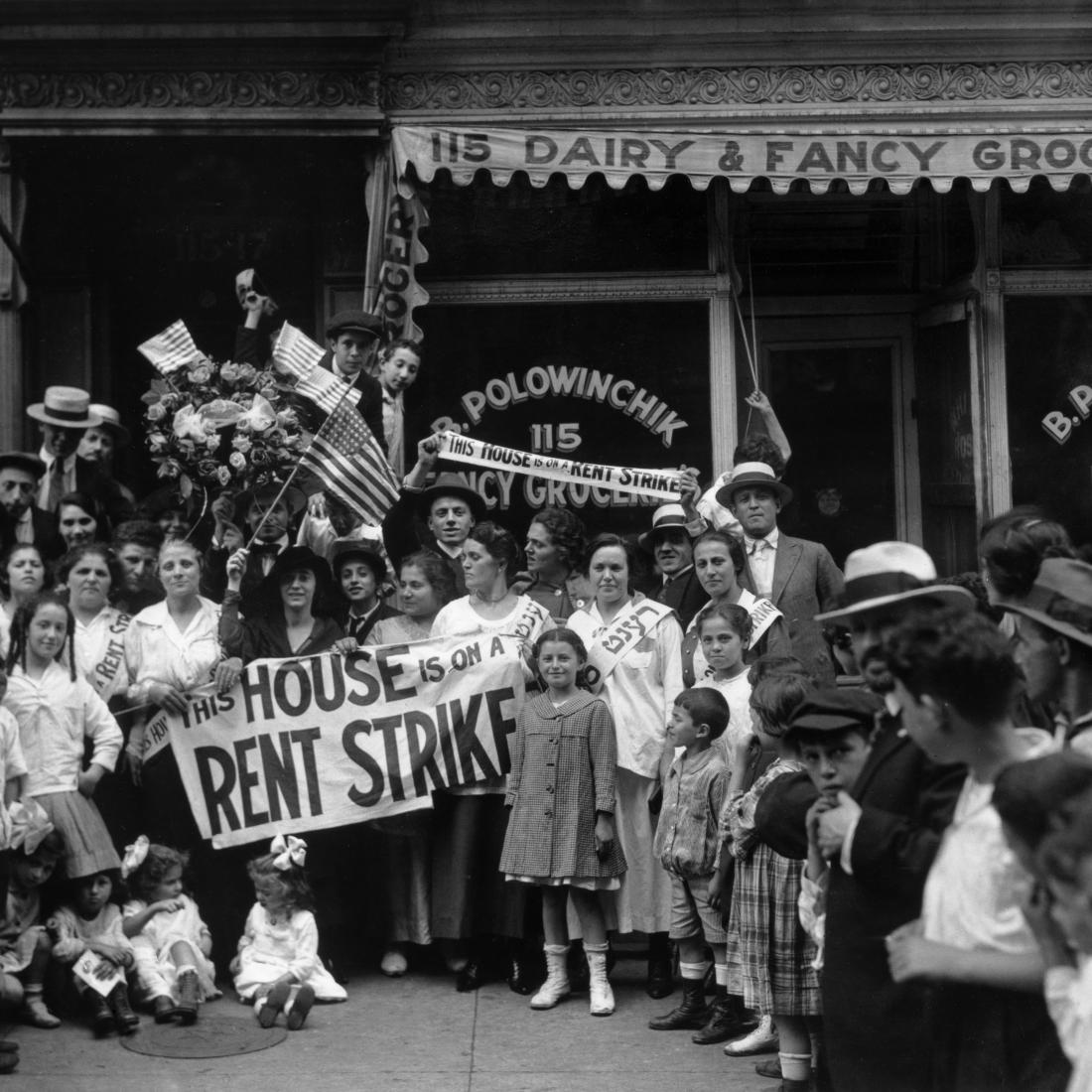 A group of men, women, and children during a rent strike in Harlem. 