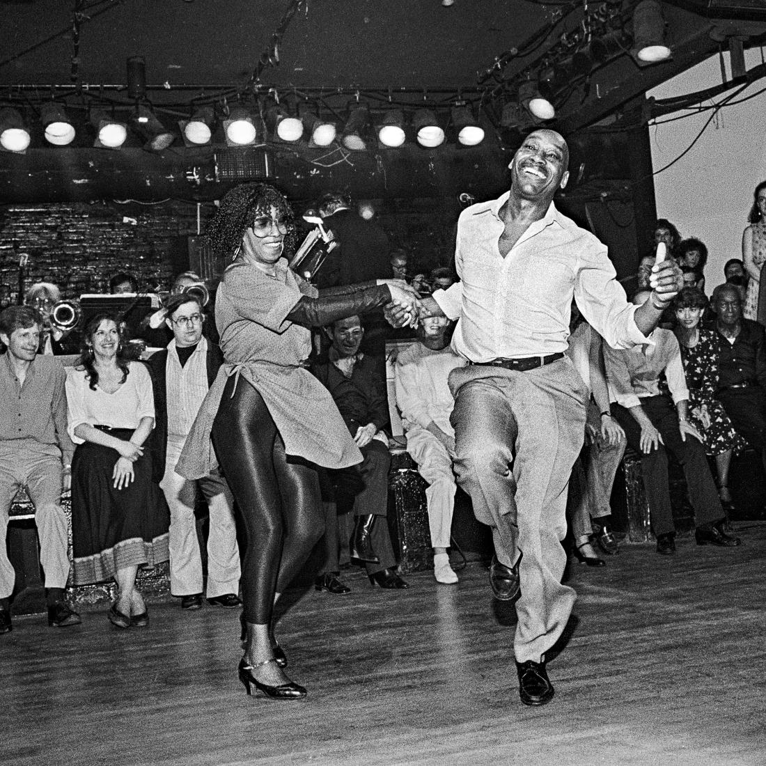 Franking Manning and Norma Miller dancing in front of a crowd.