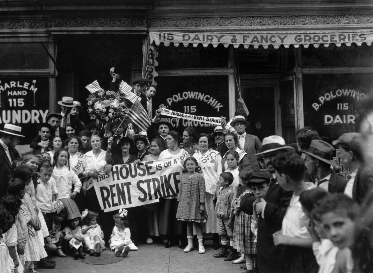 A group of men, women, and children during a rent strike in Harlem. 