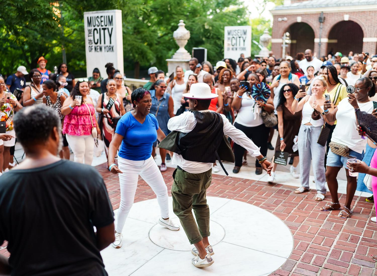 Two people dancing on the front terrace of the Museum of the City of New York