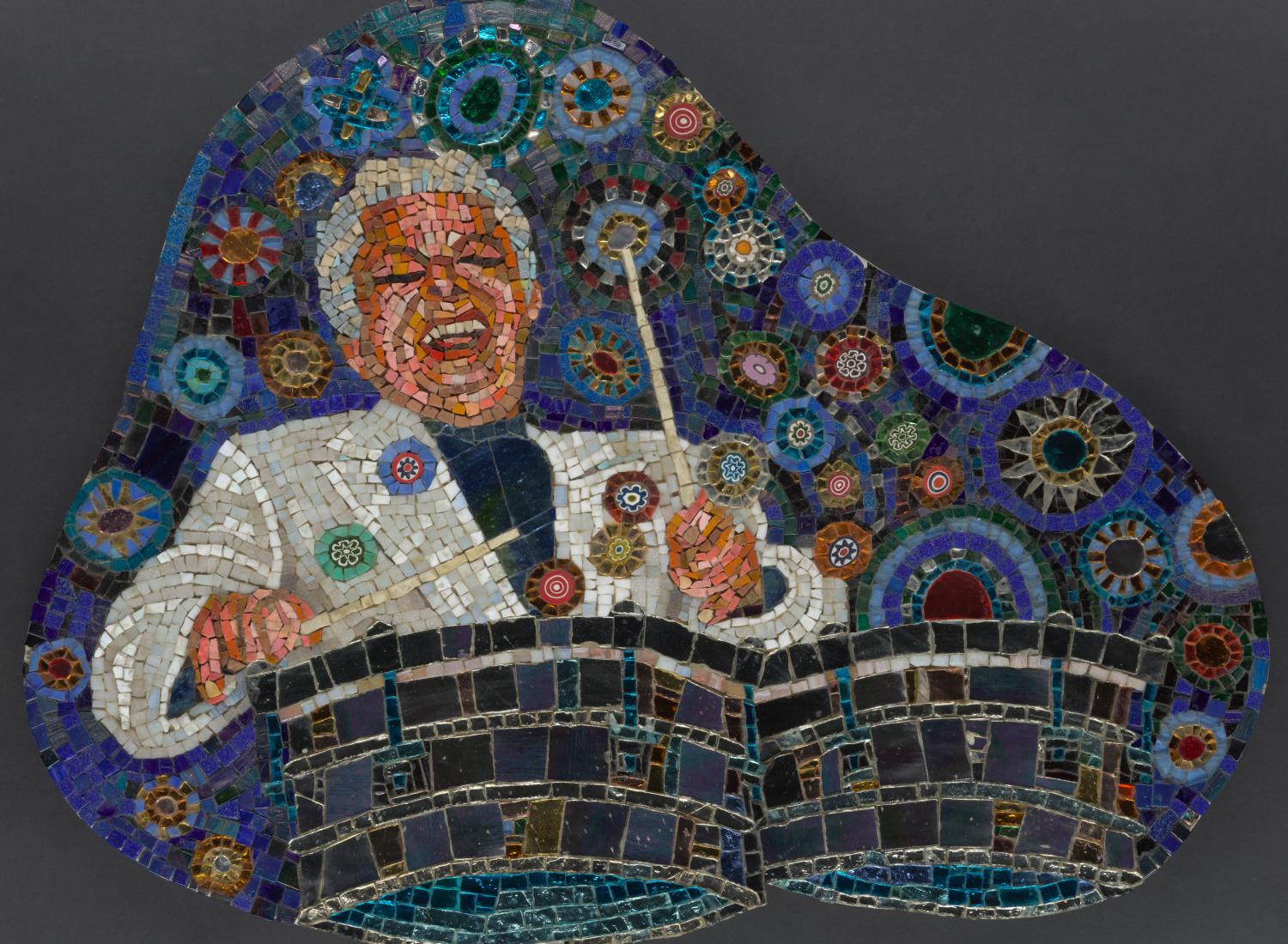 An image of a mosaic featured famed musician Tito Puente with an exuberant smile joyfully playing drums with a blue background filled with multicolored circles.