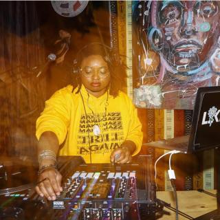 DJ LiKWUiD djing at a table. 