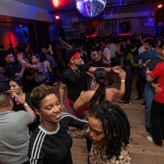 People dancing Bachata on a dance floor. 