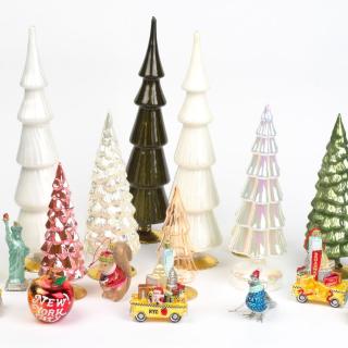 Glass Christmas Trees and ornaments in front of a white background.