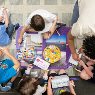 A group of students participating in an art making activity. 