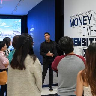 A tour guide leading a group through New York at Its Core