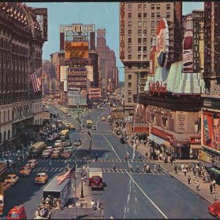 Wide view looking down the street of Times Square. 