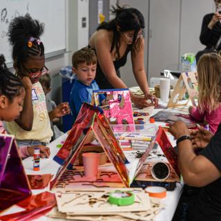 Kids making art at a table.