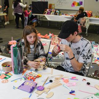 Two children work on an art project.