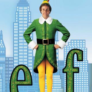 Will Ferrell standing in between the letters “e’ and “f” in a green and yellow “elf” costume with a blue background of a cityscape. 