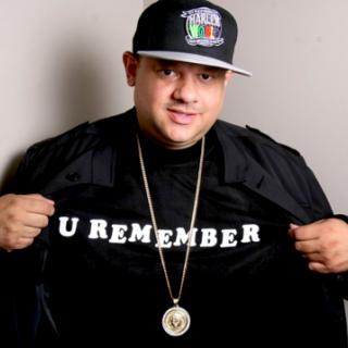 Image of DJ Ted Smooth wearing black hat and shirt that reads" U REMEMBER" 