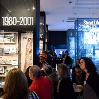 Educators listening to a tour in the New York at Its Core exhibition at the Museum of the City of New York.