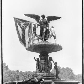 Uma fonte com uma estátua segurando a bandeira de Porto Rico